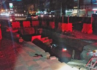 Driver survives, jumping from his motorbike before falling into construction pit in Pattaya