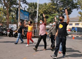 Fourteen pro-democracy activists summoned to Bangkok police station for hearing sedition charges over overnight rally in September last year