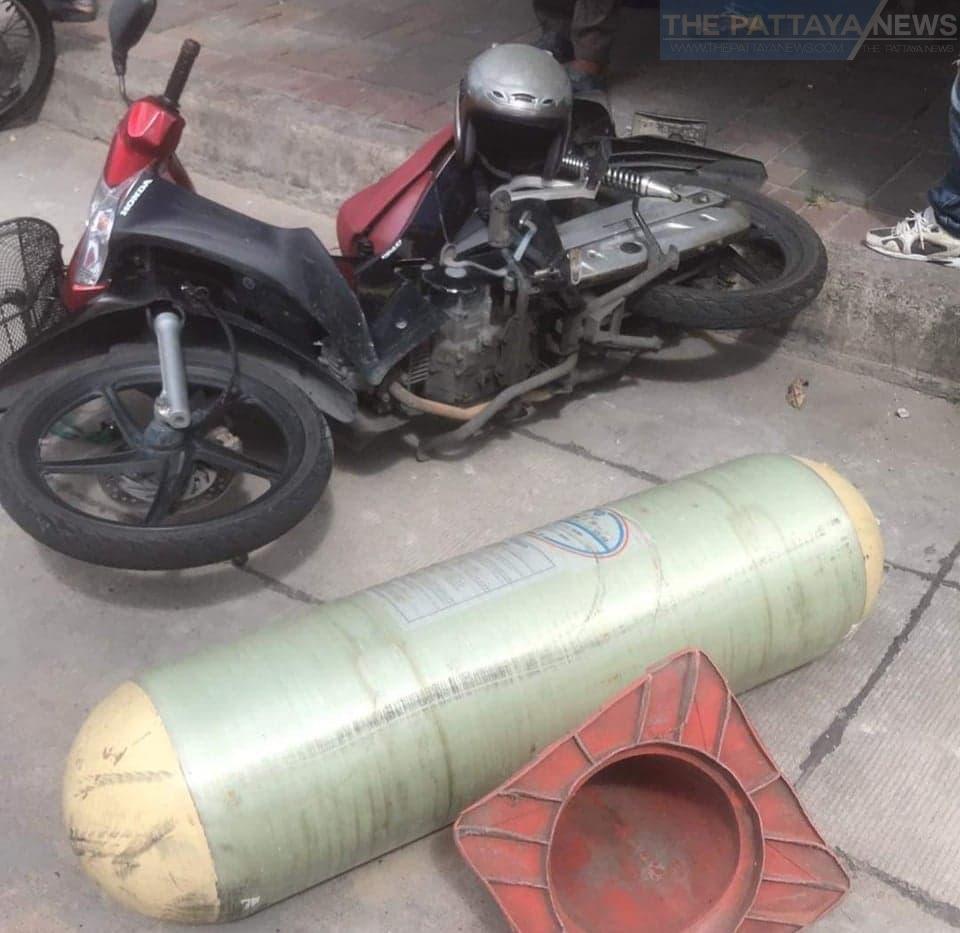Leaking compressed gas tank flies from over a 100 meters from a garage and hits two parked motorcycles in Central Pattaya