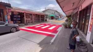 Pattaya local complains to authorities for painting needless crosswalk in front of his garage in a narrow alley