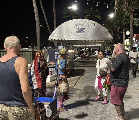 Wandering Musician Captivates Tourists with Lively Performance on Pattaya Beach