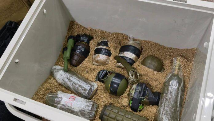 Pattaya news evidence photograph showing grenades, detonators and plastic-wrapped packages marked C4 packed in sand inside a storage box seized from a rented house in Huai Yai near Pattaya Thailand