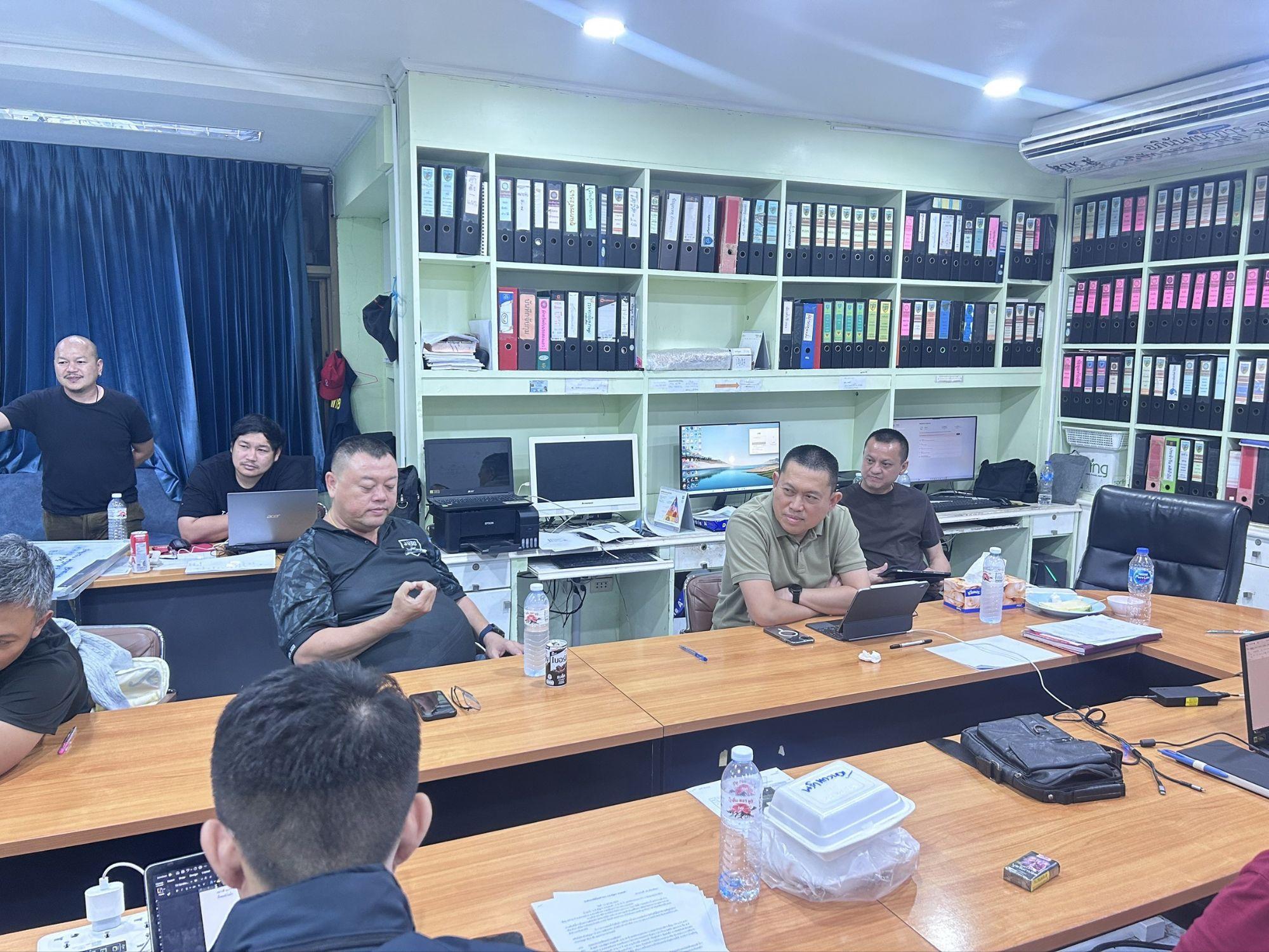 Pattaya news Thailand: police officers with suspects and seized phones, laptop and SIM cards after a fake cyber police call centre raid in Pattaya